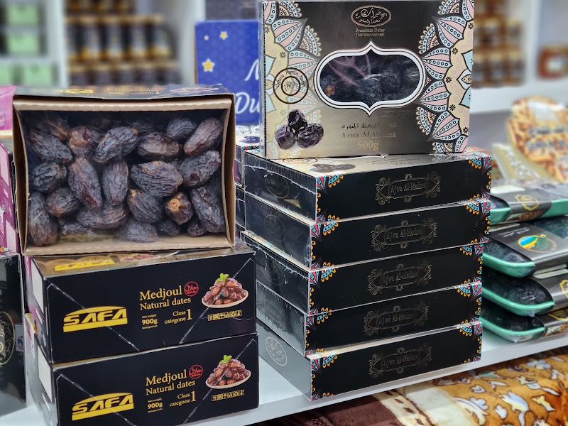 Boxes of premium Medjool dates alongside gift boxes of prayer beads