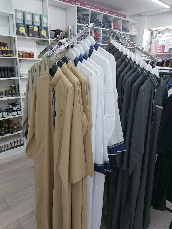 Interior view of the boutique showing clothing rails and stocked shelving
